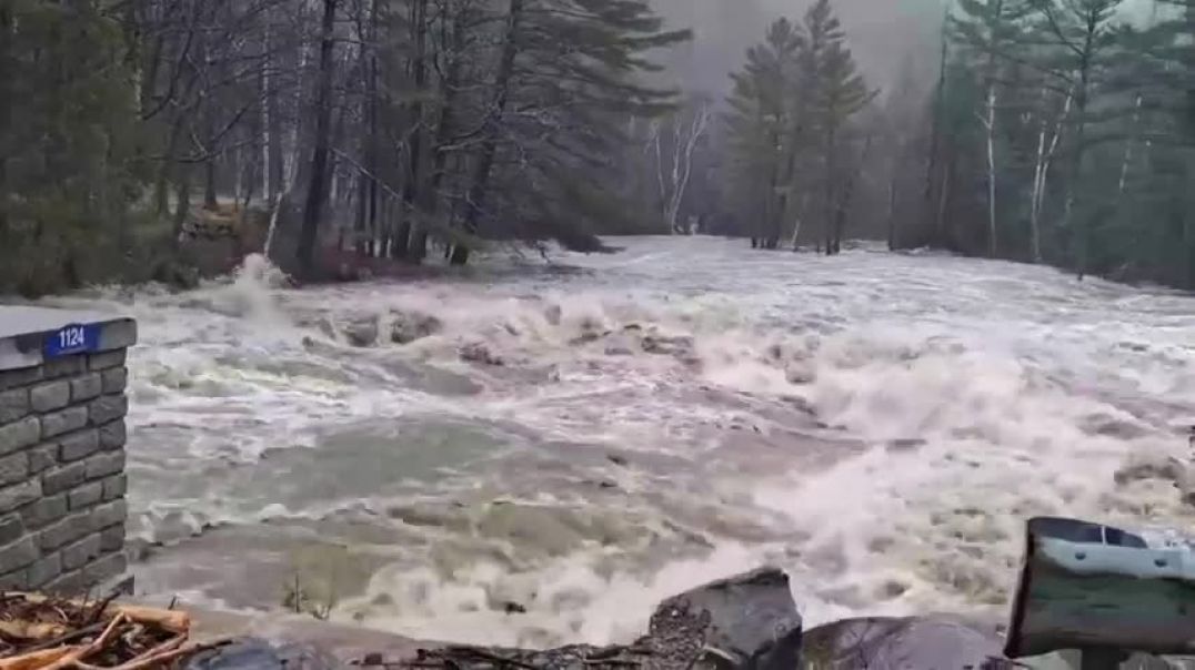 ⁣Swollen river swallows bridge in Maine as flash flooding warned