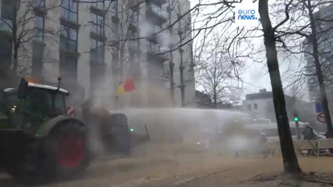 Watch Angry farmers block streets, dump manure and clash with police in Brussels